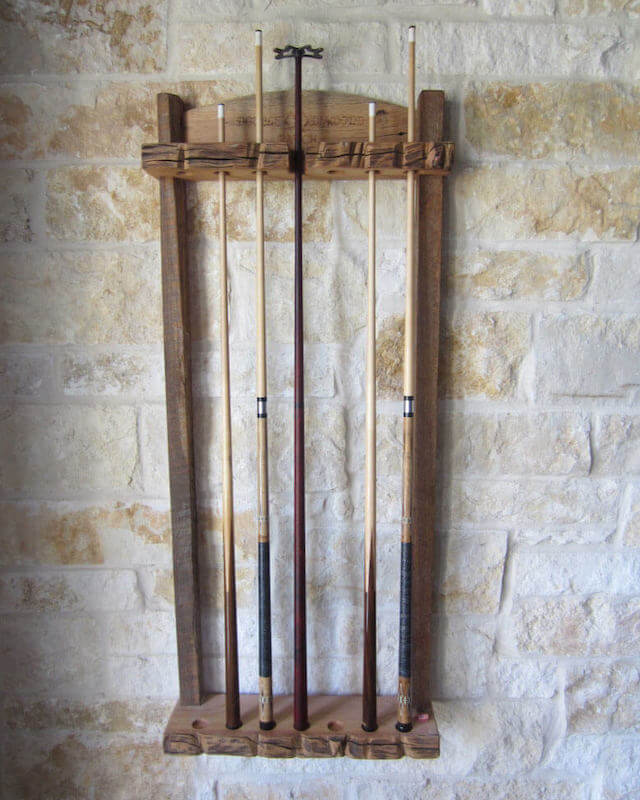 reclaimed barn wood billiard cue rack on stone wall